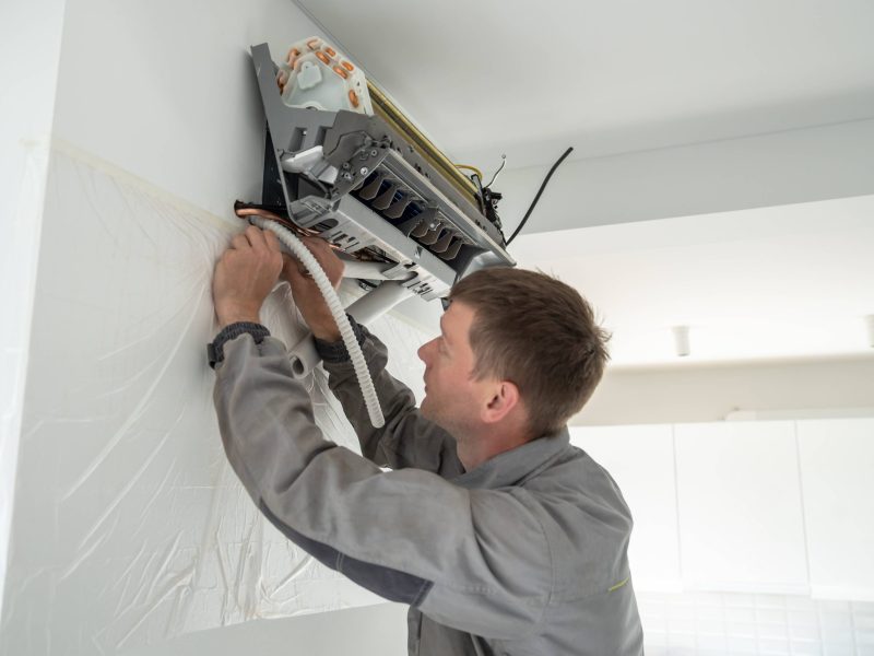 installing-air-conditioner-in-house-man-specialis-2023-11-27-05-17-14-utc